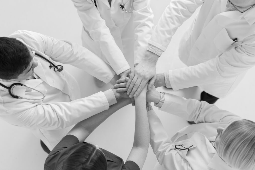 medicine-healthcare-teamwork-people-concept-group-happy-doctors-holding-hands-together-hospital-modified