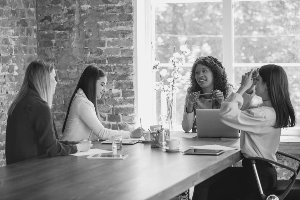 young-business-woman-modern-office-with-team-creative-meeting-tasks-giving-close-up-analytics-graphs-concept-finance-business-girl-power-inclusion-diversity-feminism-discussion-modified